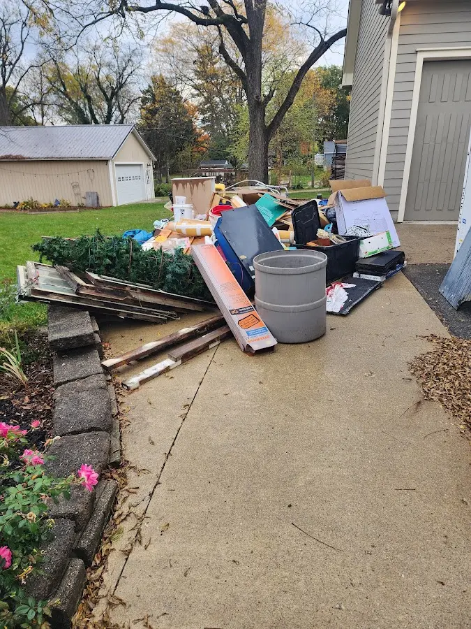 Dumpster being loaded with debris for Residential Dumpster Rental in Teague